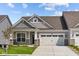 Gray and beige two-story home with a two-car garage and landscaped yard at 10626 Maidenhair Dr, Indianapolis, IN 46239