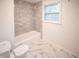 Clean bathroom with gray tile shower and marble floor at 924 Park Rd, Anderson, IN 46011