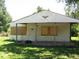 White house with boarded windows and porch at 3321 S Rybolt Ave, Indianapolis, IN 46221