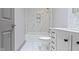 Clean bathroom, featuring a white vanity and marble tile at 4513 Norwaldo Ave, Indianapolis, IN 46205