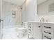 Modern bathroom with white vanity, marble shower, and bathtub at 4513 Norwaldo Ave, Indianapolis, IN 46205