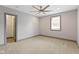 Spacious bedroom with ceiling fan, carpet, and large window at 4513 Norwaldo Ave, Indianapolis, IN 46205
