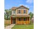 Two-story house with beige siding, brown shutters, and a wooden fence at 4513 Norwaldo Ave, Indianapolis, IN 46205