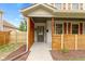 Front entrance with gray door, wood accents, and walkway at 4513 Norwaldo Ave, Indianapolis, IN 46205