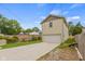 Tan detached garage with white door and a long driveway at 4513 Norwaldo Ave, Indianapolis, IN 46205