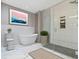 Luxurious bathroom with soaking tub, walk-in shower, and marble flooring at 4513 Norwaldo Ave, Indianapolis, IN 46205