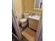 Small bathroom with beige vanity and floral wallpaper at 14 Winchester Ct, Anderson, IN 46013