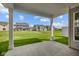 Covered patio overlooking backyard and neighboring houses at 10628 Maidenhair Dr, Indianapolis, IN 46239