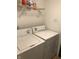 Bright laundry room with washer and dryer and shelving at 3654 Newgate Ln, Indianapolis, IN 46235