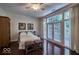Main bedroom with hardwood floors and access to a private patio at 6470 Meridian Pkwy # Apt D, Indianapolis, IN 46220