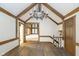 Open hallway with hardwood floors, chandelier, and access to other rooms at 6235 Johnson Rd, Indianapolis, IN 46220