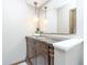 Elegant bathroom with dark vanity, granite countertop, and unique lighting at 6235 Johnson Rd, Indianapolis, IN 46220