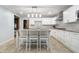 Bright kitchen featuring white cabinets, granite island, and stainless steel appliances at 6235 Johnson Rd, Indianapolis, IN 46220