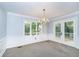 Formal dining room with chandelier, crown molding, and French doors at 6235 Johnson Rd, Indianapolis, IN 46220