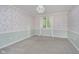 Bedroom with floral wallpaper, grey carpet and a window at 6235 Johnson Rd, Indianapolis, IN 46220