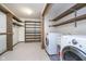 Laundry room with washer, dryer, shelving, and closet at 6235 Johnson Rd, Indianapolis, IN 46220