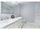 Bathroom with double vanity and marble-look tile at 6235 Johnson Rd, Indianapolis, IN 46220