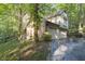 Two car garage with driveway and wooded surroundings at 6235 Johnson Rd, Indianapolis, IN 46220