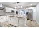 Modern kitchen with white cabinets, granite island, and stainless steel appliances at 6235 Johnson Rd, Indianapolis, IN 46220