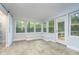 Sunroom with multiple windows, built-in bench, and sliding barn door at 6235 Johnson Rd, Indianapolis, IN 46220