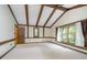 Spacious bedroom with vaulted ceiling, large window, and wood beams at 6235 Johnson Rd, Indianapolis, IN 46220
