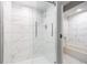 Bathroom with shower and bathtub, featuring marble-look tile at 6235 Johnson Rd, Indianapolis, IN 46220