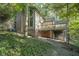 House with large windows and deck, nestled in woods at 6235 Johnson Rd, Indianapolis, IN 46220