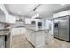 Updated kitchen with white cabinets, granite island, and stainless steel appliances at 6235 Johnson Rd, Indianapolis, IN 46220