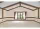 Bright bedroom with vaulted ceiling, large window, and wood beams at 6235 Johnson Rd, Indianapolis, IN 46220