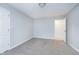 Simple bedroom with grey carpet and access to a bathroom at 6235 Johnson Rd, Indianapolis, IN 46220