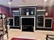 Basement home theater with built-in shelving and large screen TV at 5300 W Autumn Springs Ct, Muncie, IN 47304