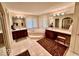 Large bathroom with double sinks, corner bathtub, and tiled floor at 5300 W Autumn Springs Ct, Muncie, IN 47304