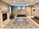 Finished basement with a sitting area, fireplace, and large rug at 5300 W Autumn Springs Ct, Muncie, IN 47304
