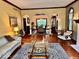 Spacious living room features hardwood floors, a fireplace, and arched entryways at 5300 W Autumn Springs Ct, Muncie, IN 47304