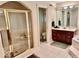 Elegant bathroom with a large soaking tub, walk-in shower, and double vanity at 5300 W Autumn Springs Ct, Muncie, IN 47304