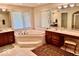 Bathroom with corner bathtub, double sinks, and tiled floor at 5300 W Autumn Springs Ct, Muncie, IN 47304