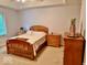 Spacious bedroom with wooden furniture and carpet flooring at 5300 W Autumn Springs Ct, Muncie, IN 47304