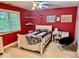 Bright bedroom with a double bed, desk, and red walls at 5300 W Autumn Springs Ct, Muncie, IN 47304