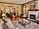 Elegant living room boasts hardwood floors, a fireplace, and arched details at 5300 W Autumn Springs Ct, Muncie, IN 47304