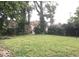 Large grassy backyard with trees and fence at 3358 Ruckle St, Indianapolis, IN 46205
