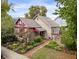 Tan house with maroon accents and a landscaped front yard at 646 E 9Th St, Indianapolis, IN 46202