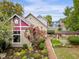 Tan house with maroon accents and a landscaped backyard at 646 E 9Th St, Indianapolis, IN 46202