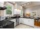 Updated kitchen with granite countertops and white cabinetry at 646 E 9Th St, Indianapolis, IN 46202