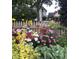 Colorful flower garden with mixed blooms in front of picket fence at 646 E 9Th St, Indianapolis, IN 46202