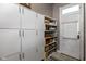White cabinets and shelving provide ample storage in this laundry room at 646 E 9Th St, Indianapolis, IN 46202
