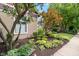 Landscaped front yard with mature trees and colorful flowers at 646 E 9Th St, Indianapolis, IN 46202