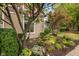 Landscaped front yard with mature trees and colorful flowers at 646 E 9Th St, Indianapolis, IN 46202