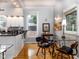 Modern kitchen with white cabinets and a breakfast nook at 646 E 9Th St, Indianapolis, IN 46202