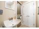 Small bathroom with pedestal sink, mirror, and access to a bedroom at 646 E 9Th St, Indianapolis, IN 46202