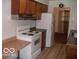 Kitchen with white appliances and wood cabinets at 4013 N Audubon Rd, Indianapolis, IN 46226